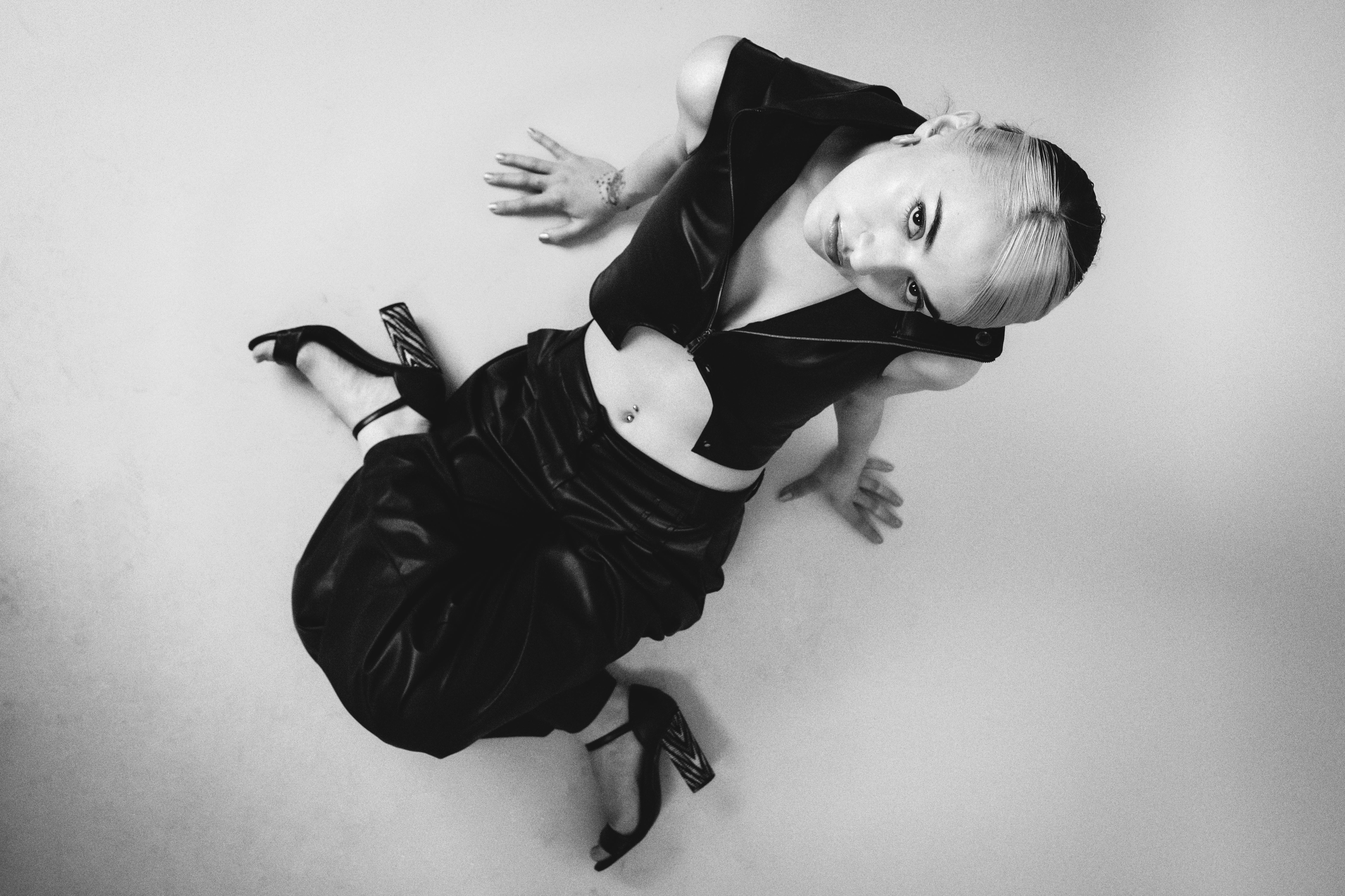 Woman Wearing a Vest Sitting on the Floor